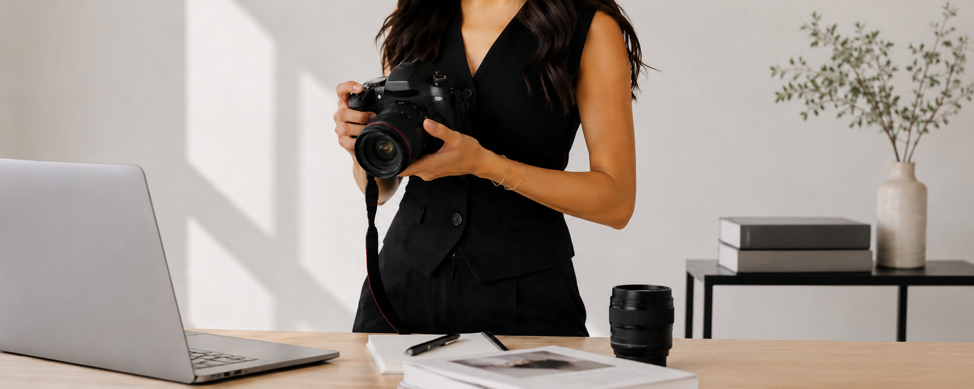 Mia Harris, founder of Harris Sphere, with camera and laptop at her desk